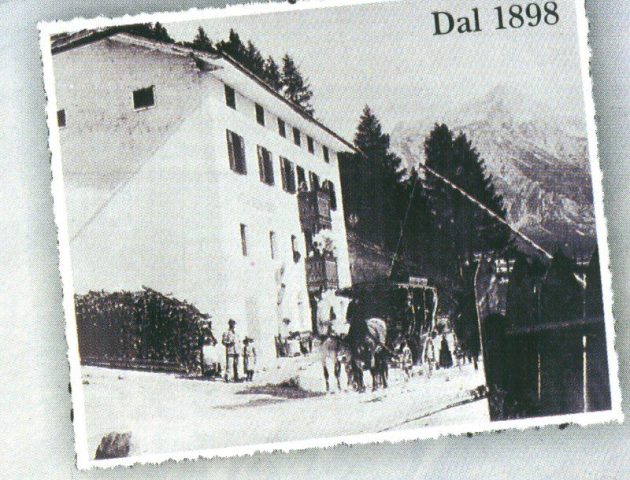 Foto storica dell'Hotel Des Alpes in stile cartolina, in alto a destra la scritta "Dal 1898"